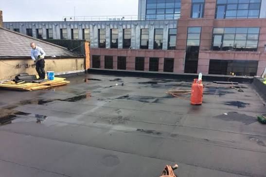 Commercial flat roof repair in progress