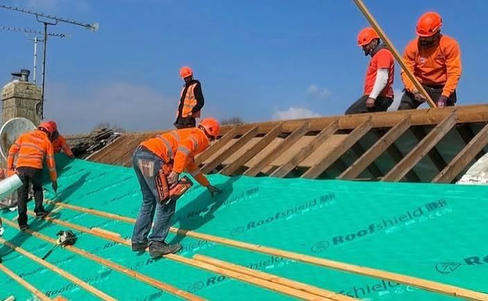 Roofing team installing a new roof membrane near Market Harborough
